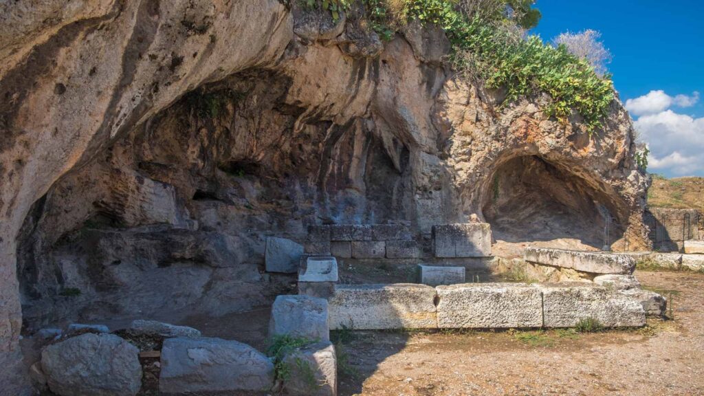Discover the ancient stone ruins set in rocky terrain with lush vegetation under Athens' clear blue sky. As you explore, add this to your list of things to do when visiting Athens, where history and beauty create a timeless tapestry all year round.