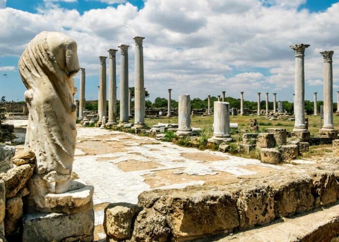 Rows of re-erected marble columns at the gymnasium of ancient Salamis, Cyprus, with the Mediterranean behind